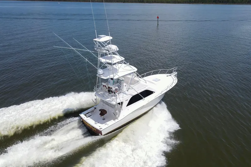 Slide: The Image of 2005 Cabo 40 Flybridge yacht cruising on open water, aerial view. - 105