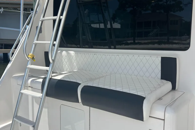 Slide: The Image of Cabo 40 Flybridge 2005 boat with cushioned seating and ladder. - 16