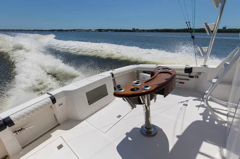 Slide: The Image of 2005 Cabo 40 Flybridge boat cruising on open water, featuring a sleek fishing cockpit. - 17