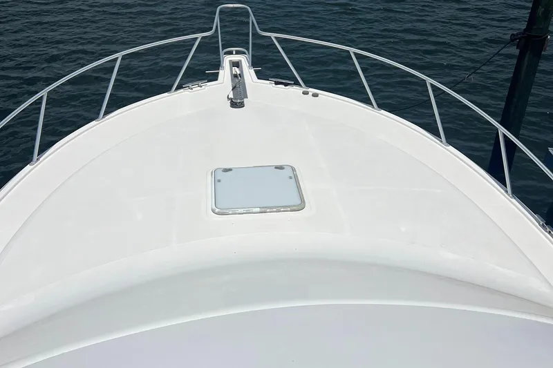 Slide: The Image of Bow of 2005 Cabo 40 Flybridge yacht on calm water. - 18