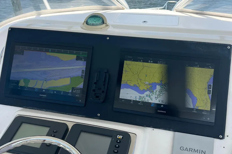 Slide: The Image of Navigation screens on a 2005 Cabo 40 Flybridge boat dashboard. - 22