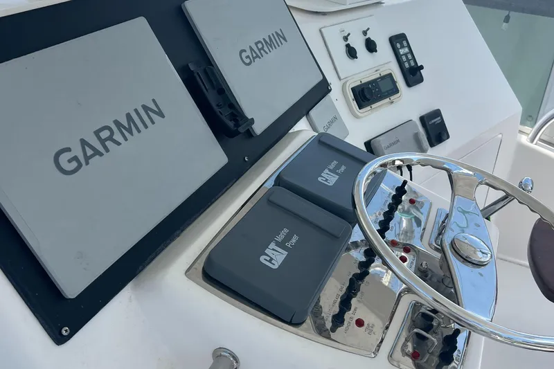 Slide: The Image of Control panel of a 2005 Cabo 40 Flybridge with Garmin navigation systems. - 25