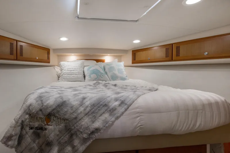 Slide: The Image of Luxurious cabin interior of 2005 Cabo 40 Flybridge yacht with cozy bedding. - 38