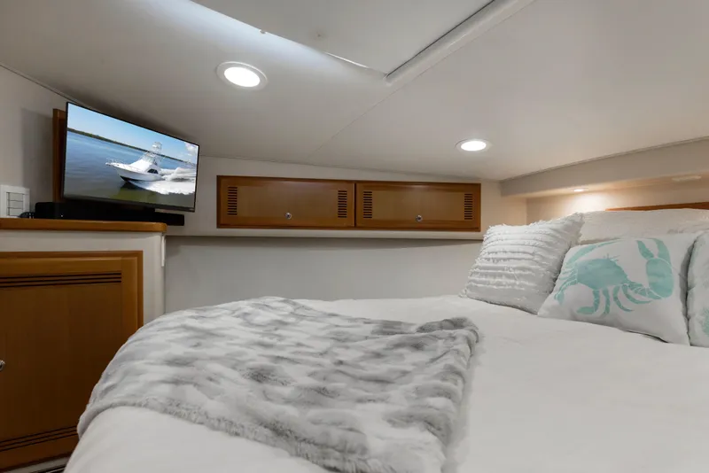 Slide: The Image of Cozy cabin interior of 2005 Cabo 40 Flybridge with bed, TV, and nautical decor. - 40
