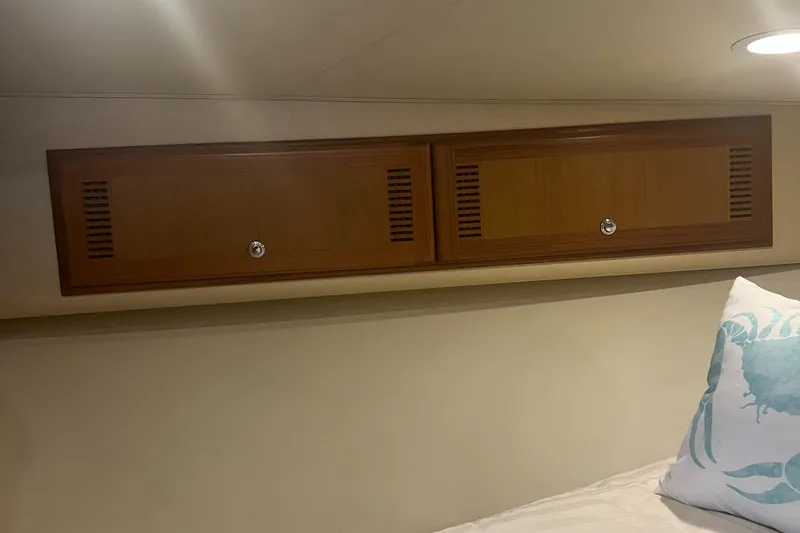 Slide: The Image of 2005 Cabo 40 Flybridge interior with wooden cabinets and decorative pillow. - 45