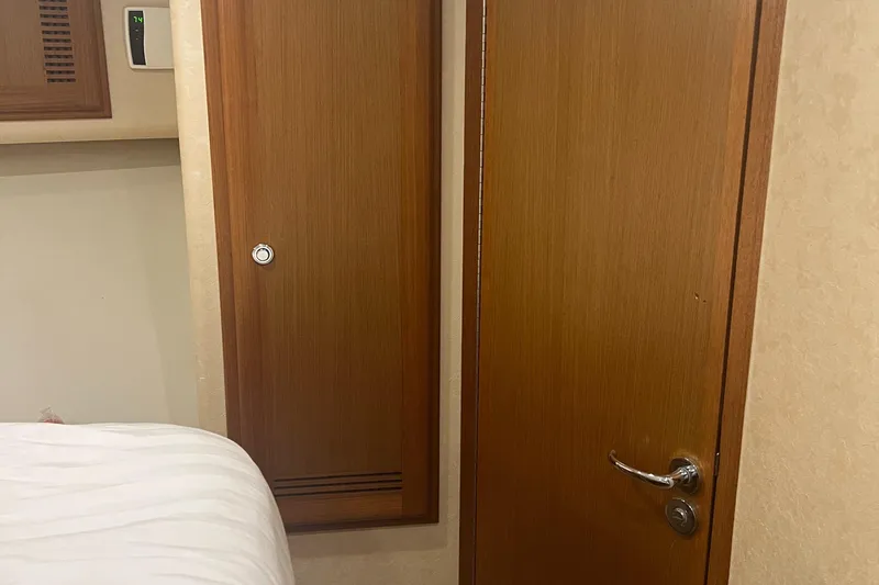 Slide: The Image of Interior of 2005 Cabo 40 Flybridge yacht showing wooden door and paneling. - 47