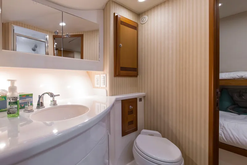 Slide: The Image of Luxurious bathroom in 2005 Cabo 40 Flybridge yacht with modern fixtures and cozy design. - 48