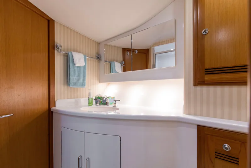 Slide: The Image of Luxurious bathroom interior of 2005 Cabo 40 Flybridge yacht with wooden cabinets and modern fixtures. - 49