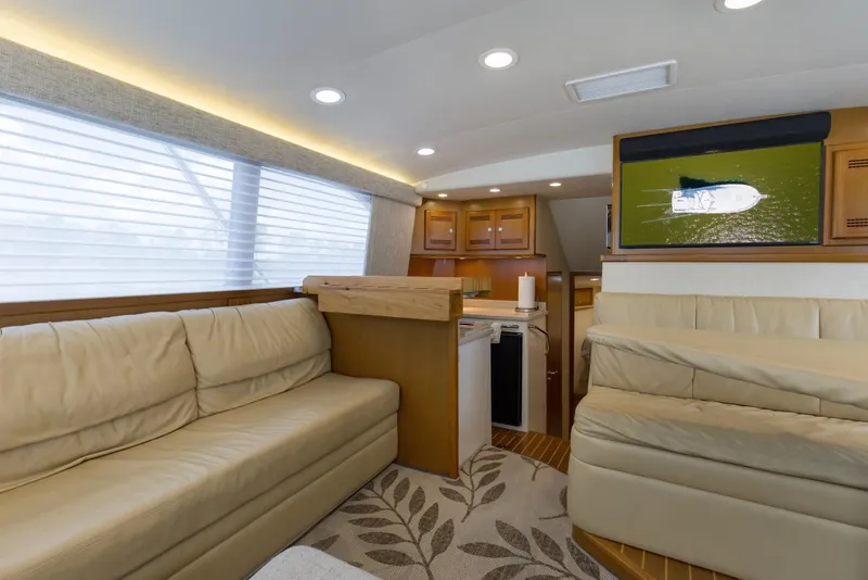 Slide: The Image of Luxurious interior of 2005 Cabo 40 Flybridge yacht with plush seating and modern amenities. - 58