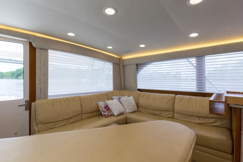 Slide: The Image of Luxurious interior of 2005 Cabo 40 Flybridge yacht with beige leather seating and soft lighting. - 59