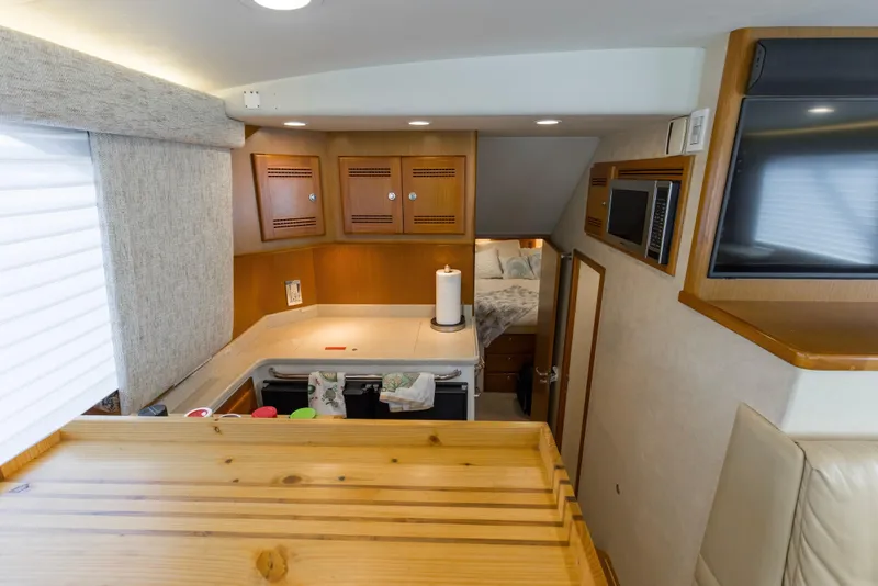 Slide: The Image of Interior of 2005 Cabo 40 Flybridge yacht with kitchen and cozy sleeping area. - 62