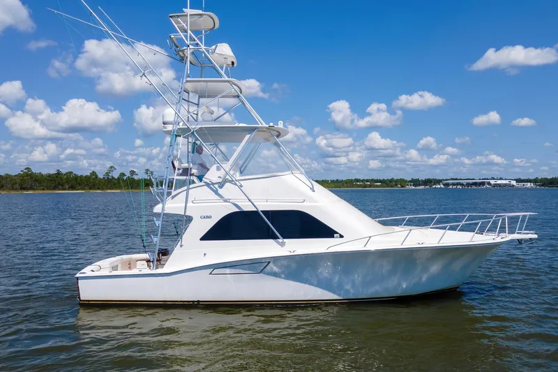 Slide: The Image of 2005 Cabo 40 Flybridge yacht on calm water under a blue sky. - 79