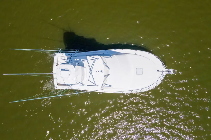 Slide: The Image of Aerial view of 2005 Cabo 40 Flybridge boat on green water. - 80