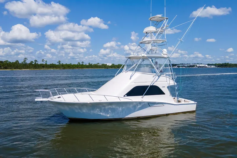 Slide: The Image of 2005 Cabo 40 Flybridge yacht cruising on a sunny day with blue skies. - 82