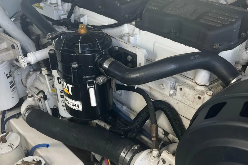Slide: The Image of Engine compartment of a 2005 Cabo 40 Flybridge with CAT components and hoses. - 84