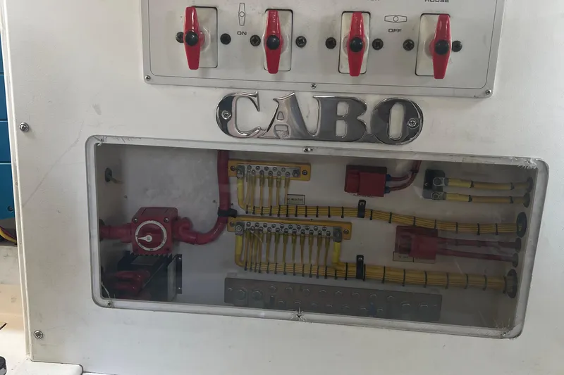 Slide: The Image of Electrical panel of 2005 Cabo 40 Flybridge boat with switches and wiring. - 90