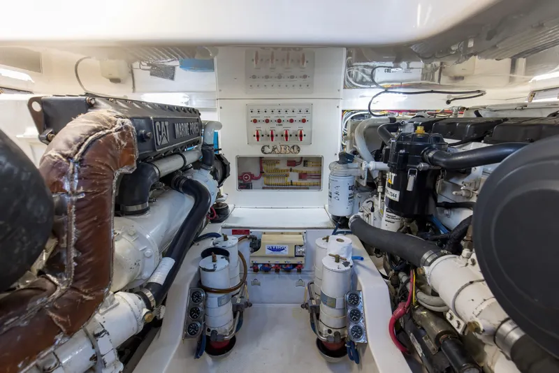 Slide: The Image of Engine room of a 2005 Cabo 40 Flybridge yacht, featuring CAT Marine Power engines. - 92