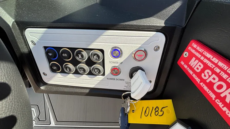 Slide: The Image of Control panel of 2025 MB B52 25 Alpha boat with labeled buttons and key. - 12