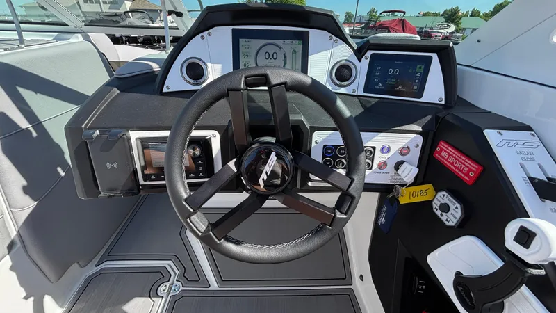 Slide: The Image of 2025 MB B52 25 Alpha boat dashboard with steering wheel and digital displays. - 15