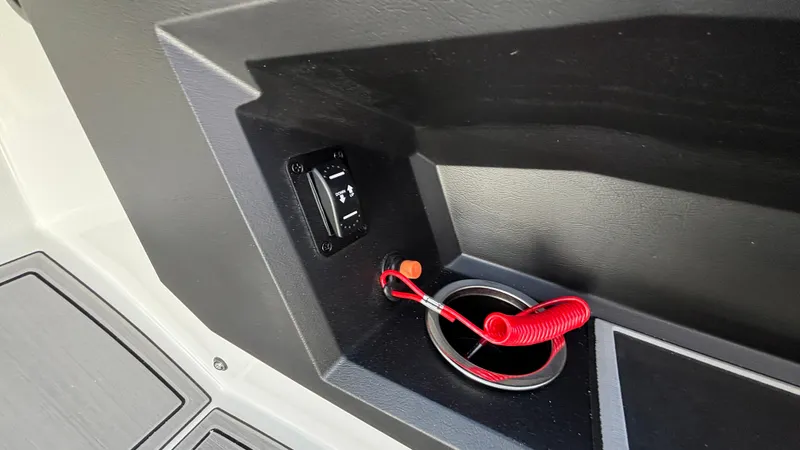 Slide: The Image of 2025 MB B52 25 Alpha boat interior with switch and red coiled cord. - 16