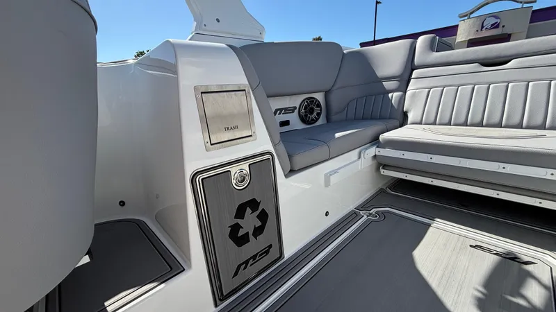 Slide: The Image of 2025 MB B52 25 Alpha boat interior with seating, speaker, and recycling bin. - 18
