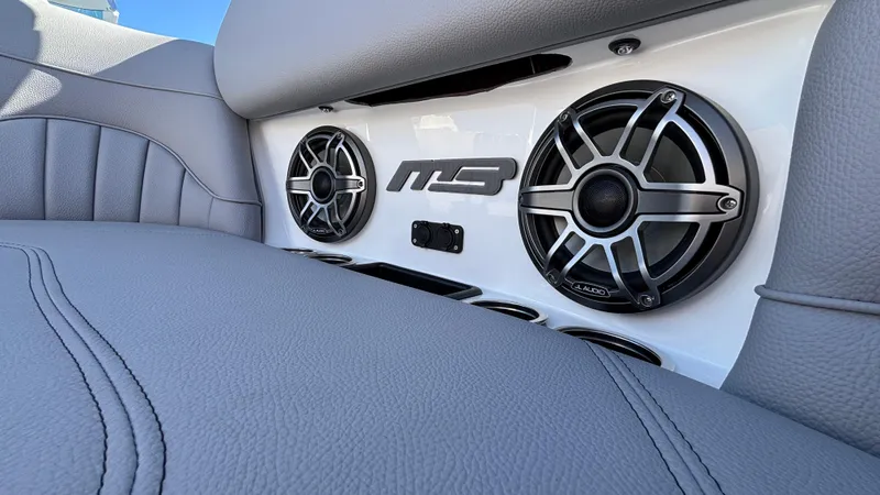 Slide: The Image of 2025 MB B52 25 Alpha boat interior with JL Audio speakers and gray upholstery. - 23