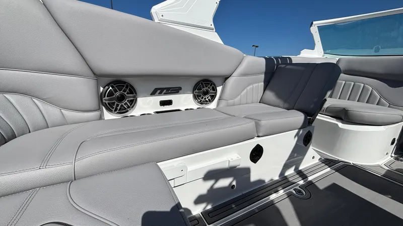 Slide: The Image of 2025 MB B52 25 Alpha boat interior with gray seating and built-in speakers. - 28