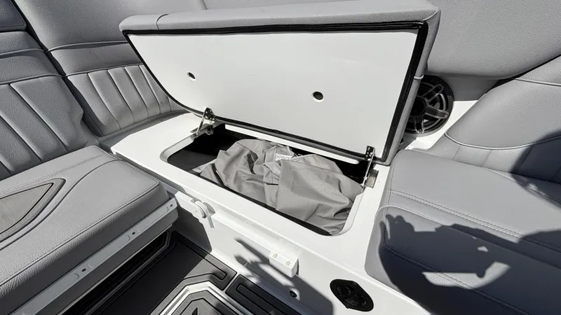 Slide: The Image of Open storage compartment in 2025 MB B52 25 Alpha boat with gray seating. - 31