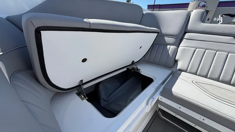 Slide: The Image of Open storage compartment in 2025 MB B52 25 Alpha boat with gray seating. - 32