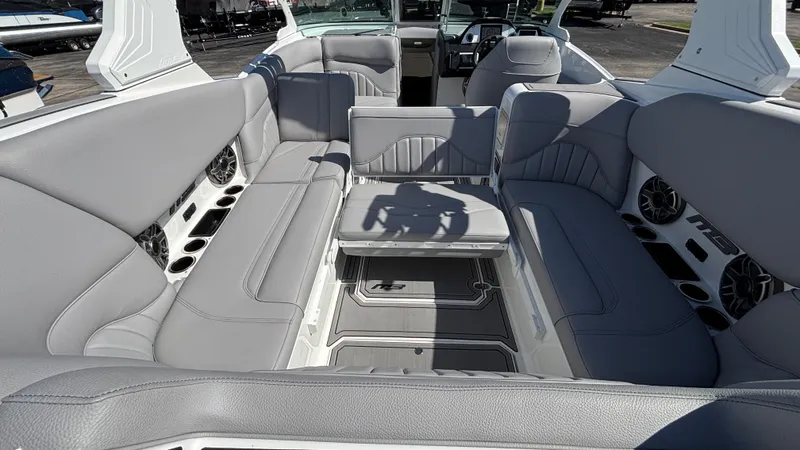 Slide: The Image of 2025 MB B52 25 Alpha boat interior with gray seating and built-in speakers. - 35
