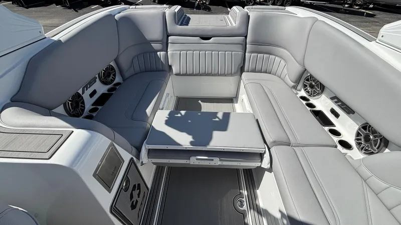 Slide: The Image of Interior of 2025 MB B52 25 Alpha boat with gray seating and speakers. - 37