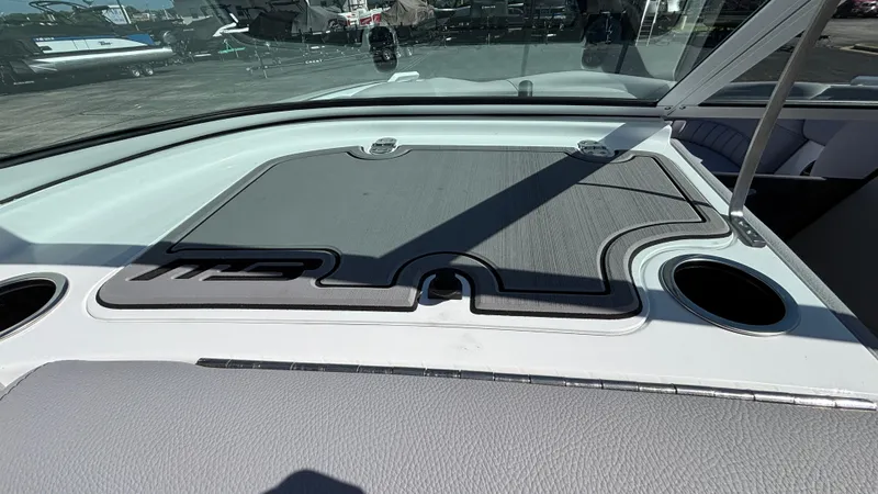 Slide: The Image of 2025 MB B52 25 Alpha boat interior with cup holders and sleek dashboard design. - 39