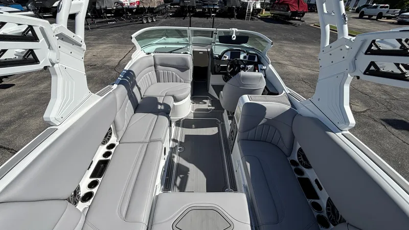 Slide: The Image of 2025 MB B52 25 Alpha boat interior with sleek gray seating and modern dashboard. - 7
