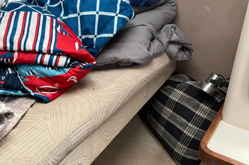 Slide: The Image of Cozy cabin interior with colorful bedding on a Trojan 12 Meter Convertible, 1988 model. - 52