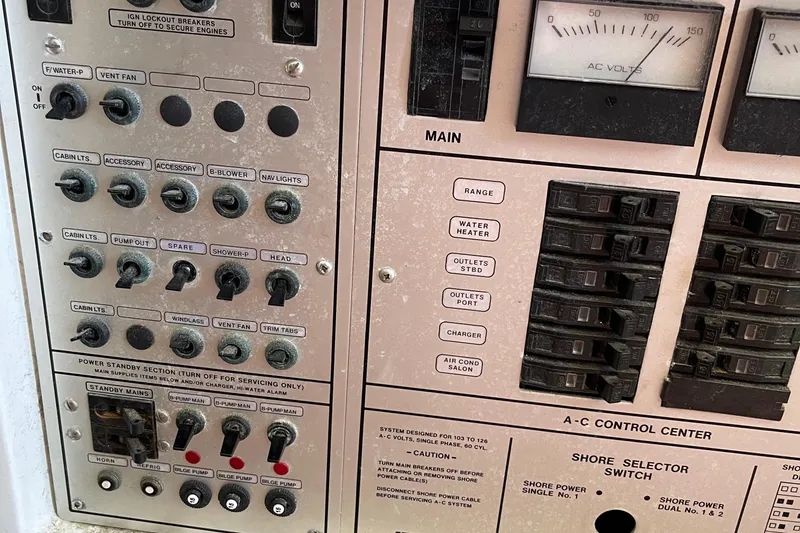 Slide: The Image of Control panel of a 1988 Trojan 12 Meter Convertible boat with switches and circuit breakers. - 32
