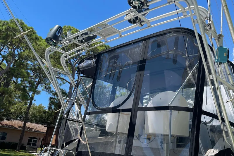 Slide: The Image of 1988 Trojan 12 Meter Convertible boat with clear enclosure and metal framework. - 4