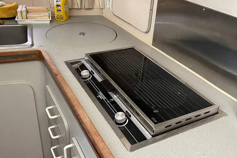 Slide: The Image of 1988 Trojan 12 Meter Convertible yacht kitchen with built-in stovetop and sink. - 41