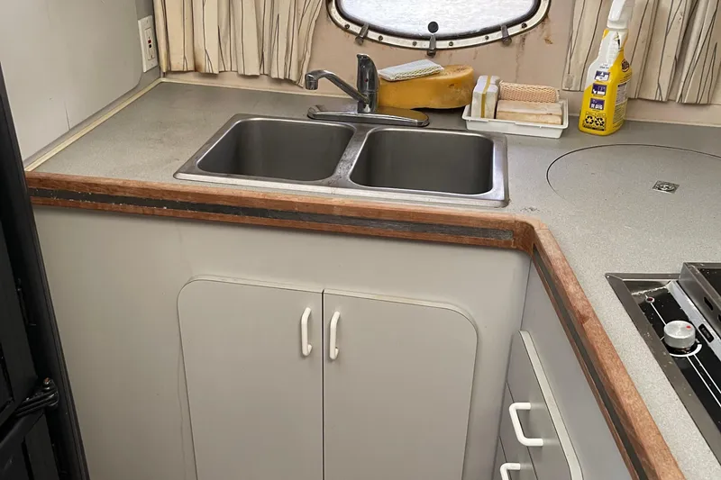 Slide: The Image of 1988 Trojan 12 Meter Convertible yacht kitchen with dual sinks and countertop. - 42
