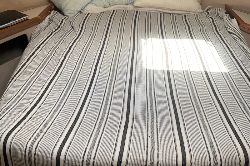 Slide: The Image of Striped bedspread in 1988 Trojan 12 Meter Convertible cabin. - 44