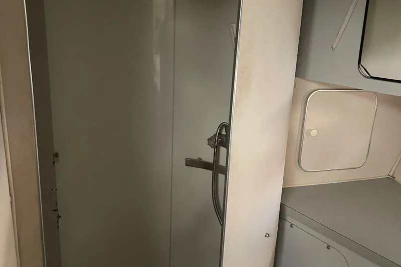 Slide: The Image of 1988 Trojan 12 Meter Convertible yacht bathroom with shower and storage. - 45