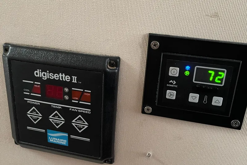 Slide: The Image of Control panels on a 1988 Trojan 12 Meter Convertible boat, displaying temperature settings. - 48