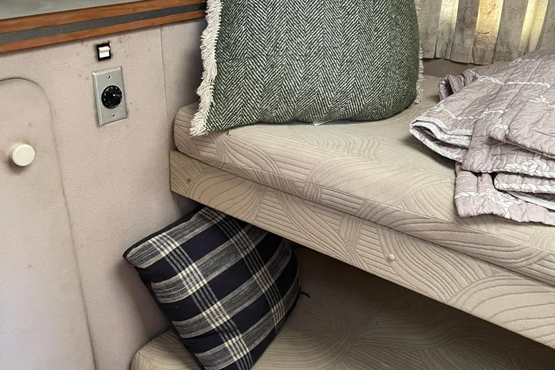 Slide: The Image of Interior of 1988 Trojan 12 Meter Convertible with cushions and bedding. - 51