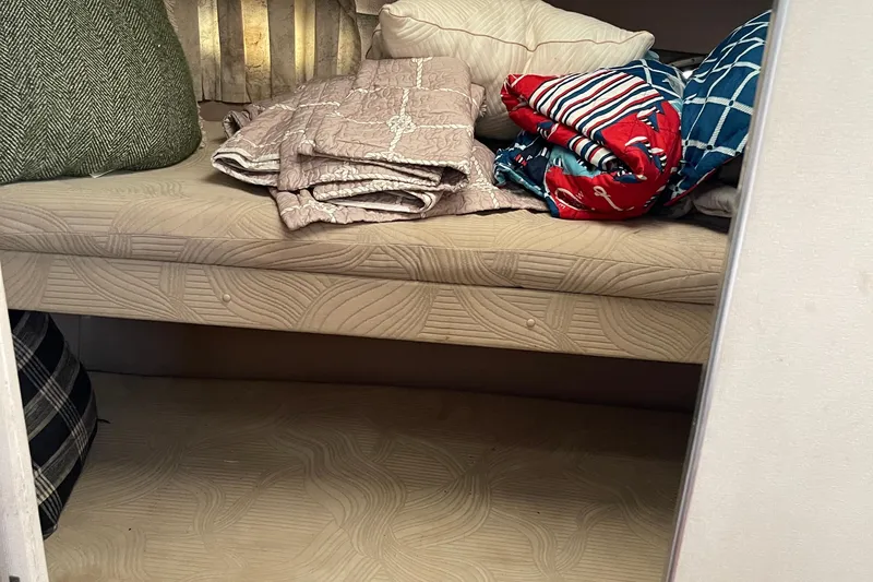 Slide: The Image of Interior of 1988 Trojan 12 Meter Convertible with cushions and folded blankets. - 53