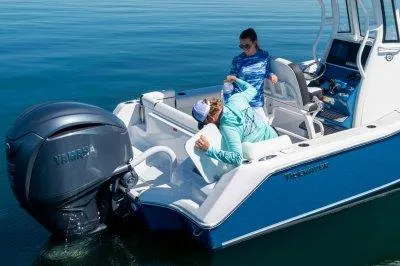 Slide: The Image of 2026 Tidewater 232 LXF boat with Yamaha engine, two people onboard, calm water setting. - 4