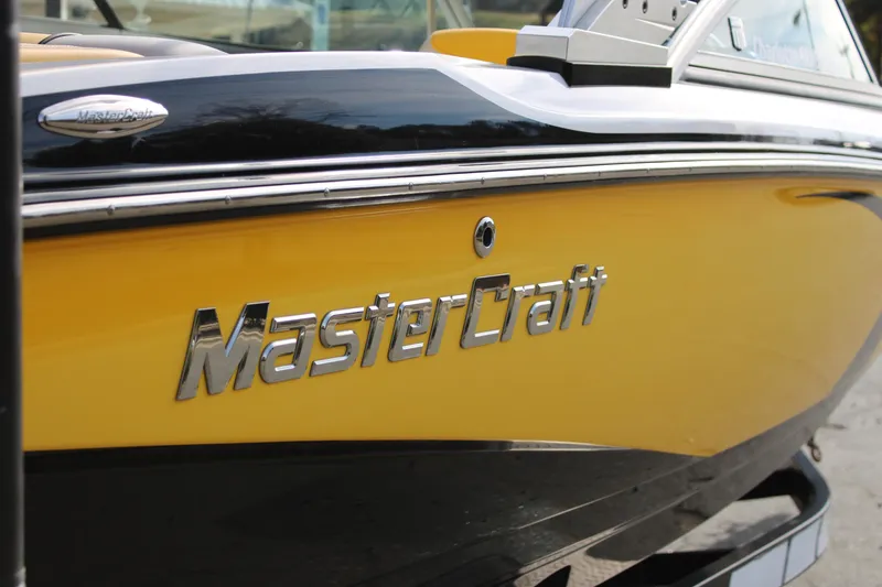Slide: The Image of 2013 MasterCraft X-2 boat, yellow and black, close-up of logo and hull design. - 20