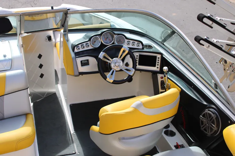Slide: The Image of 2013 MasterCraft X-2 boat interior with yellow seats and modern dashboard controls. - 26