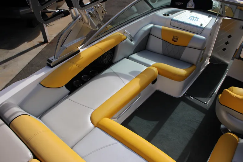 Slide: The Image of 2013 MasterCraft X-2 boat interior with yellow and white seating, showcasing luxury design. - 27