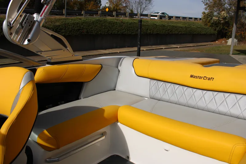 Slide: The Image of 2013 MasterCraft X-2 boat interior with yellow and gray seating. - 29