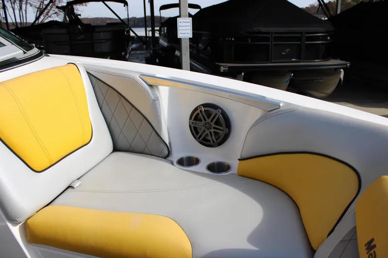 Slide: The Image of 2013 MasterCraft X-2 boat interior with yellow and gray seating, speaker, and cup holders. - 33