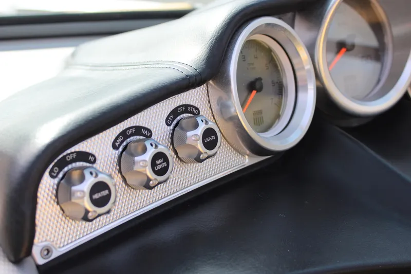 Slide: The Image of Dashboard controls of a 2013 MasterCraft X-2 boat with gauges and switches. - 36